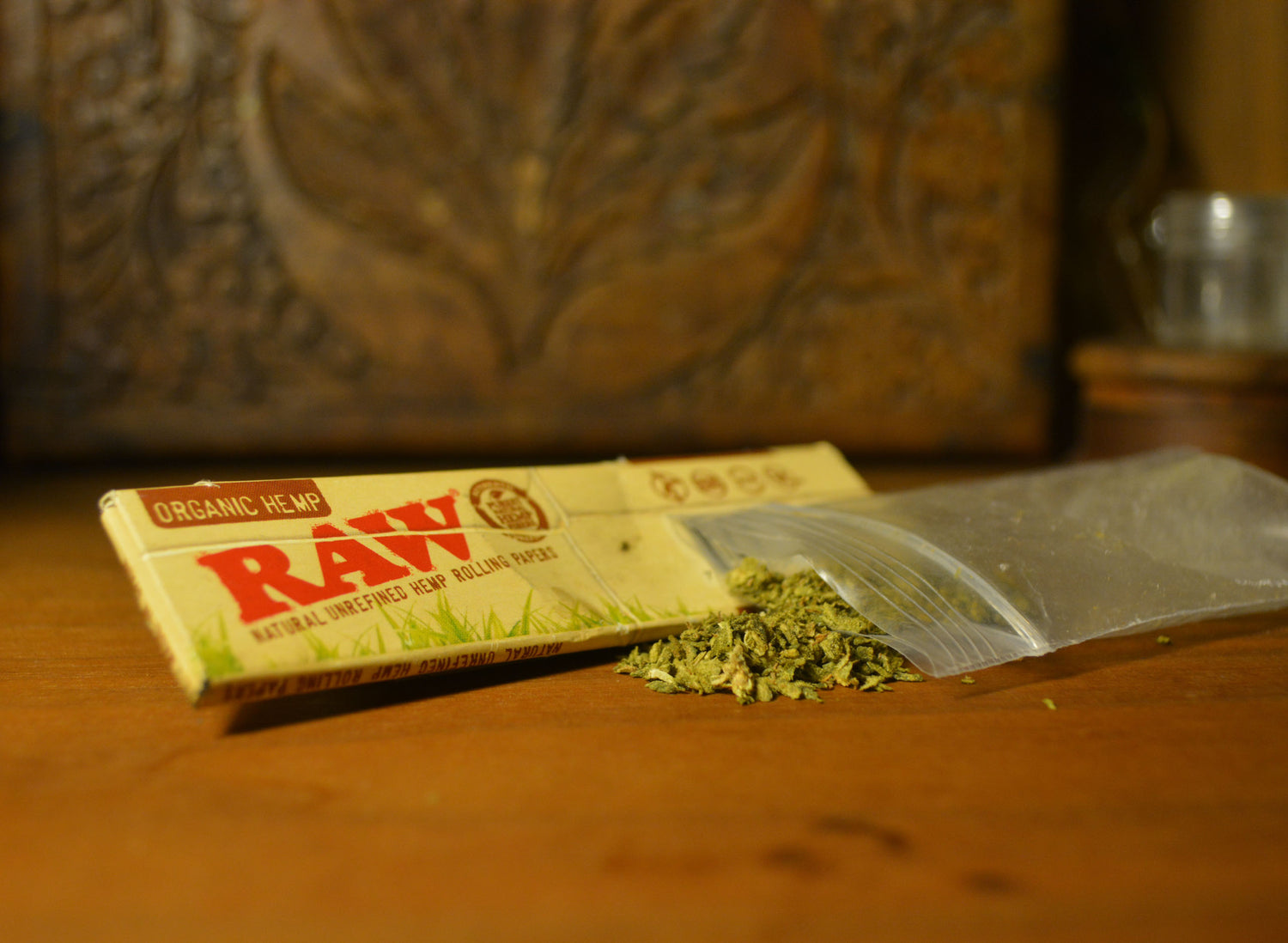 The word "raw" in bold, glossy turquoise letters on a purple background