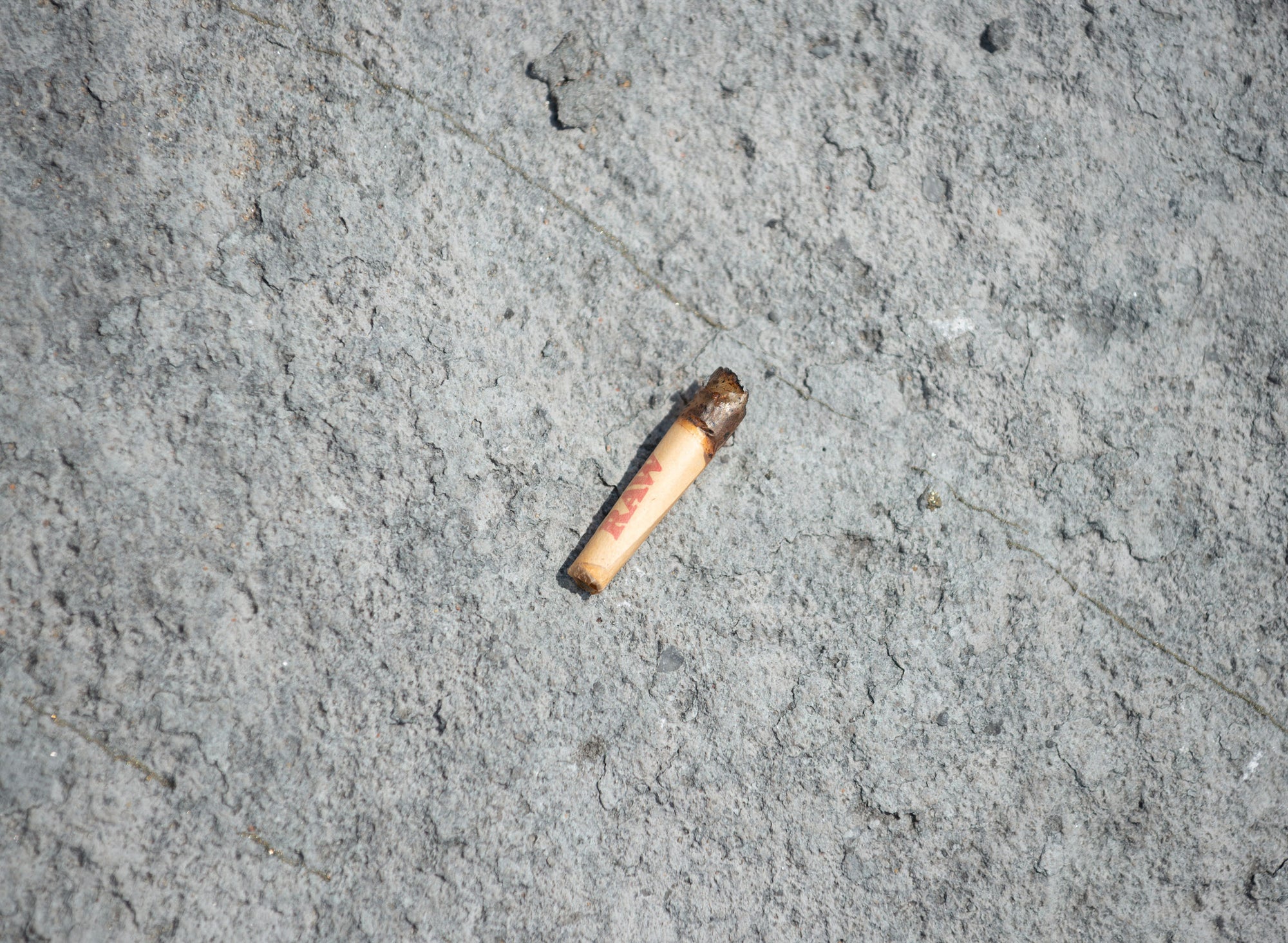 Large cigarette and two stacked white filters on an orange background